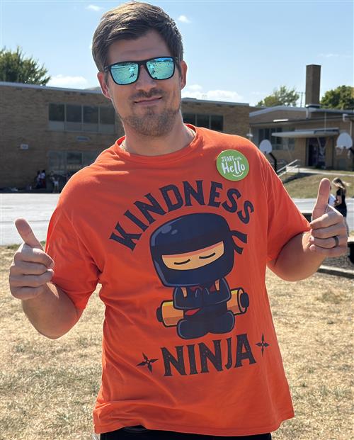 Teacher in  Kindness Ninja T-Shirt with Thumbs Up!